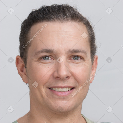 Joyful white adult male with short  brown hair and brown eyes