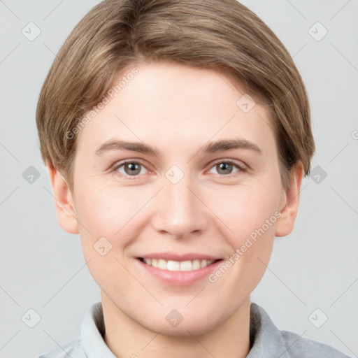 Joyful white young-adult female with short  brown hair and grey eyes