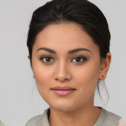 Joyful latino young-adult female with medium  brown hair and brown eyes