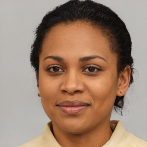 Joyful latino adult female with short  black hair and brown eyes