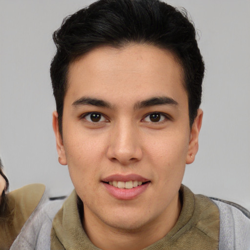 Joyful latino young-adult male with short  brown hair and brown eyes