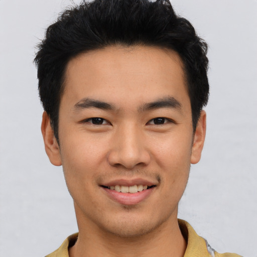 Joyful asian young-adult male with short  black hair and brown eyes