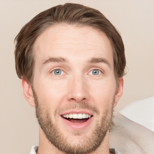 Joyful white young-adult male with short  brown hair and grey eyes