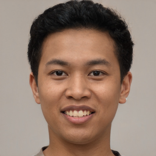 Joyful asian young-adult male with short  black hair and brown eyes