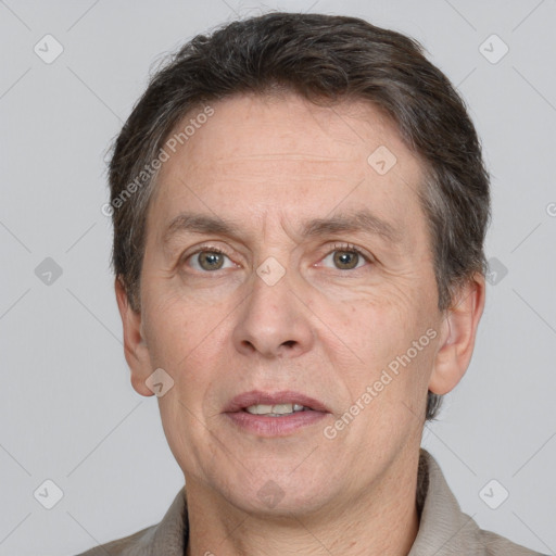 Joyful white adult male with short  brown hair and grey eyes