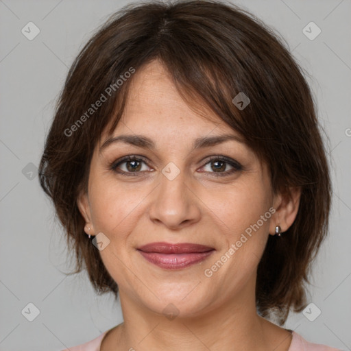 Joyful white adult female with medium  brown hair and brown eyes