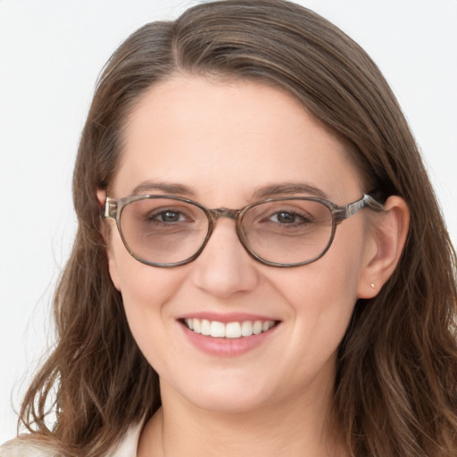 Joyful white young-adult female with long  brown hair and blue eyes