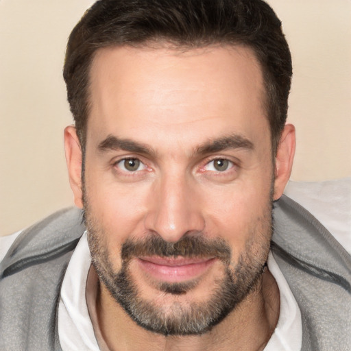 Joyful white adult male with short  brown hair and brown eyes