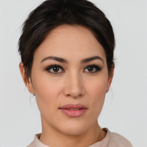 Joyful latino young-adult female with medium  brown hair and brown eyes