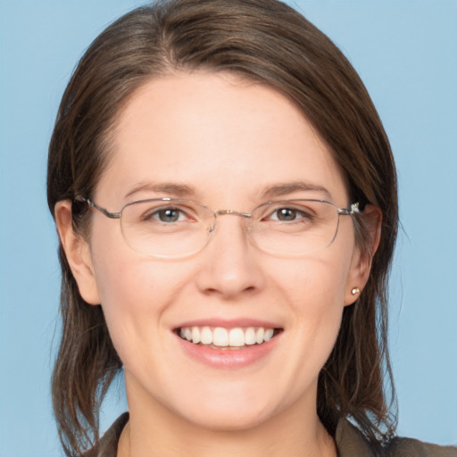 Joyful white adult female with medium  brown hair and grey eyes