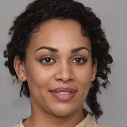 Joyful black adult female with medium  brown hair and brown eyes