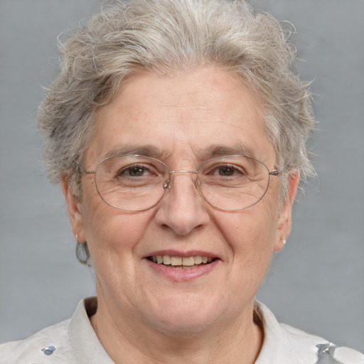 Joyful white middle-aged female with short  gray hair and brown eyes