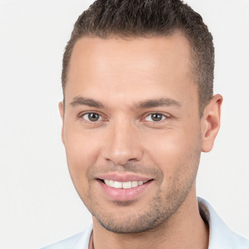 Joyful white young-adult male with short  brown hair and brown eyes