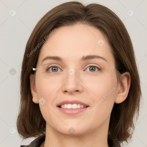 Joyful white young-adult female with medium  brown hair and grey eyes