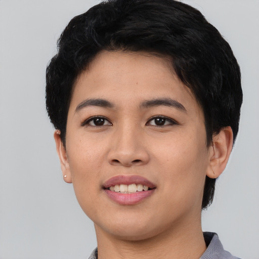 Joyful asian young-adult female with short  black hair and brown eyes