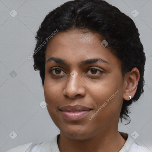 Joyful black young-adult female with short  black hair and brown eyes