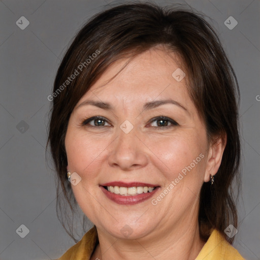 Joyful white adult female with medium  brown hair and brown eyes