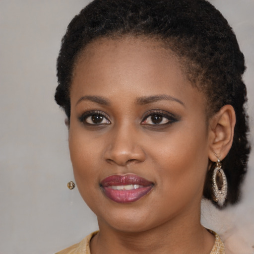 Joyful black young-adult female with long  brown hair and brown eyes