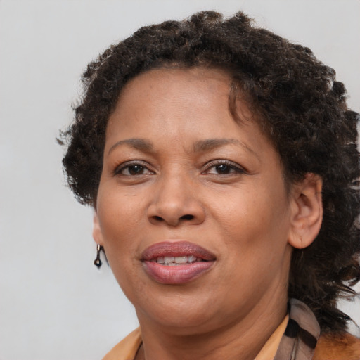 Joyful black adult female with medium  brown hair and brown eyes
