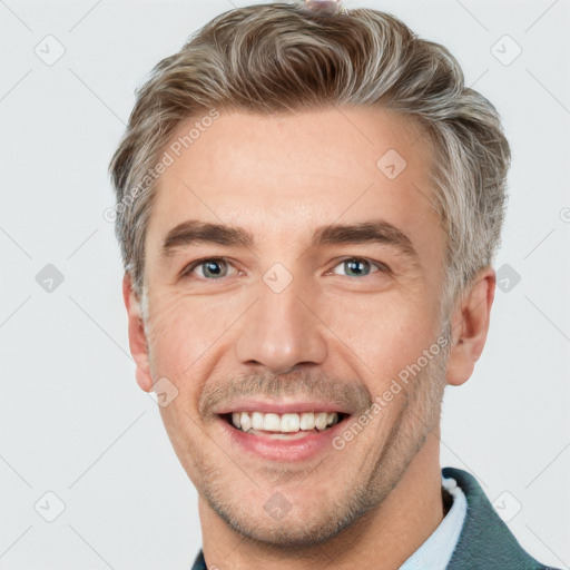 Joyful white adult male with short  brown hair and grey eyes