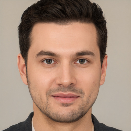 Joyful white young-adult male with short  brown hair and brown eyes