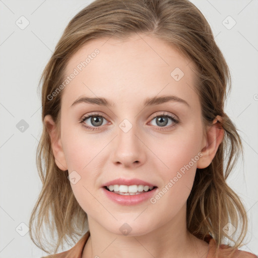 Joyful white young-adult female with medium  brown hair and blue eyes