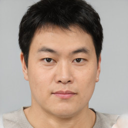 Neutral asian young-adult male with short  brown hair and brown eyes