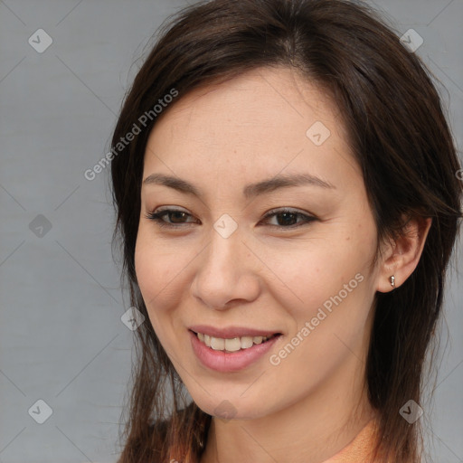 Joyful white young-adult female with long  brown hair and brown eyes