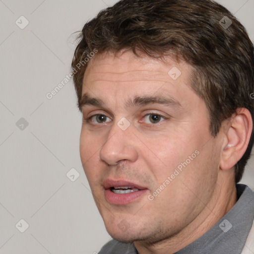 Joyful white adult male with short  brown hair and brown eyes