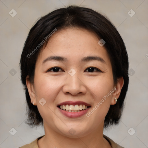 Joyful asian young-adult female with medium  brown hair and brown eyes