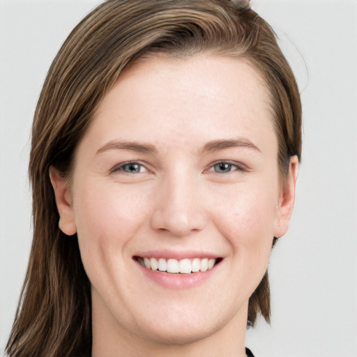 Joyful white young-adult female with long  brown hair and grey eyes