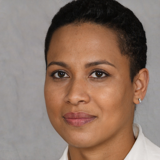 Joyful black young-adult female with short  black hair and brown eyes