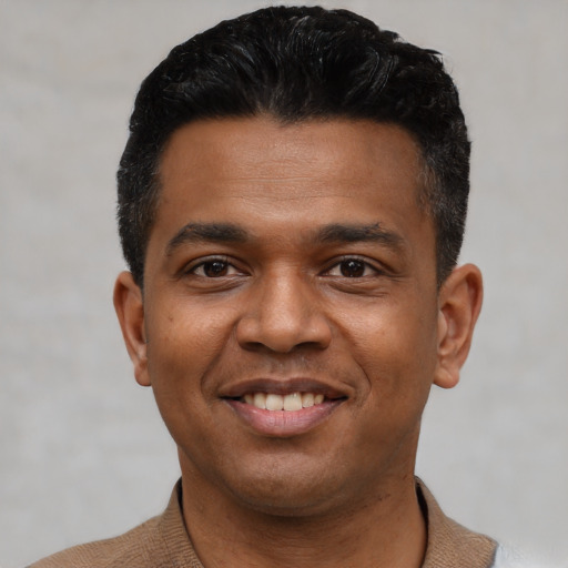 Joyful latino young-adult male with short  black hair and brown eyes