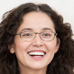 Joyful white adult female with long  brown hair and brown eyes