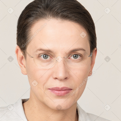 Joyful white adult female with short  brown hair and grey eyes