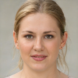 Joyful white young-adult female with medium  brown hair and green eyes