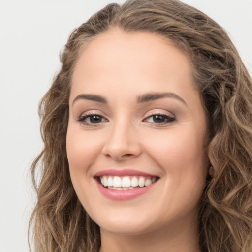 Joyful white young-adult female with long  brown hair and green eyes