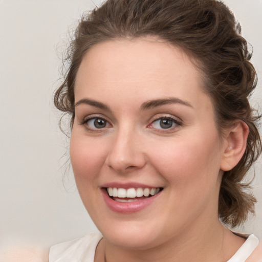 Joyful white young-adult female with medium  brown hair and blue eyes