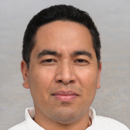 Joyful white adult male with short  black hair and brown eyes