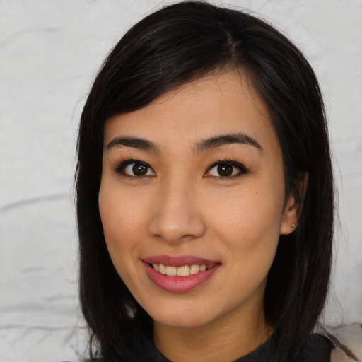 Joyful asian young-adult female with long  black hair and brown eyes