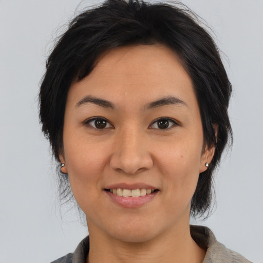 Joyful asian young-adult female with medium  brown hair and brown eyes