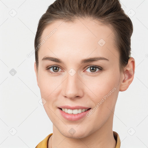 Joyful white young-adult female with short  brown hair and brown eyes