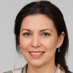 Joyful white adult female with medium  brown hair and brown eyes