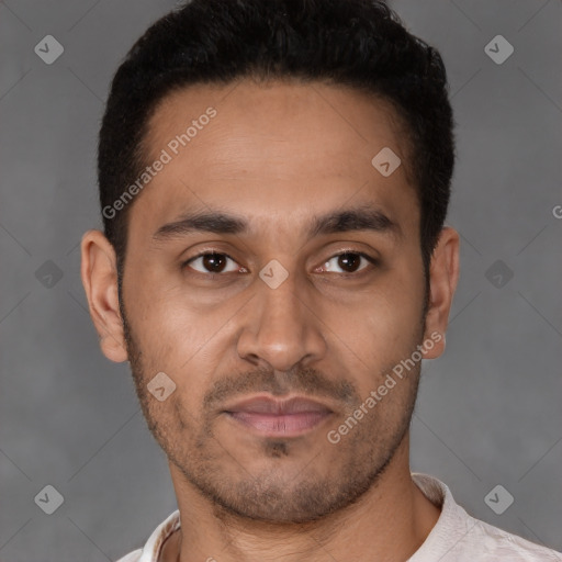 Joyful latino young-adult male with short  brown hair and brown eyes