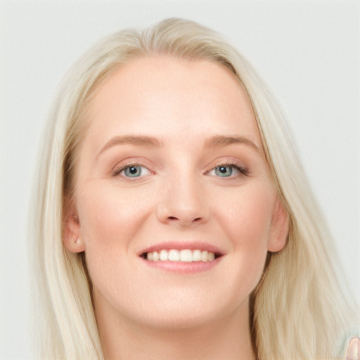 Joyful white young-adult female with long  brown hair and blue eyes