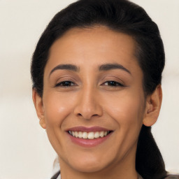 Joyful latino young-adult female with long  brown hair and brown eyes