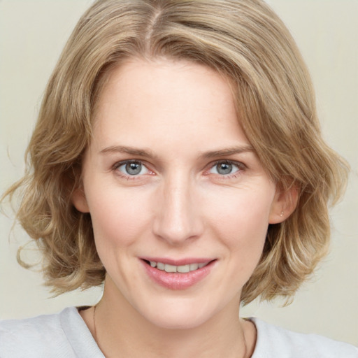 Joyful white young-adult female with medium  brown hair and green eyes