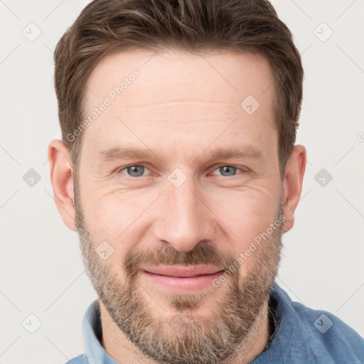 Joyful white adult male with short  brown hair and grey eyes