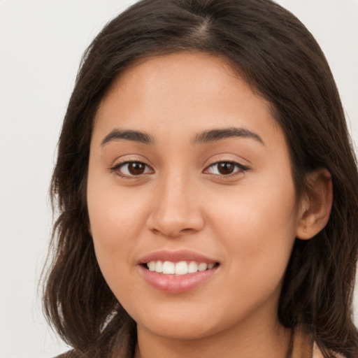 Joyful white young-adult female with long  brown hair and brown eyes