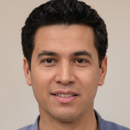 Joyful white young-adult male with short  black hair and brown eyes